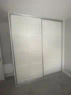 2 door sliding wardrobe with twin caraway panels in white with brushed silver frames, fitted in Thirsk